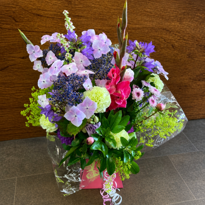Pastel Garden - A soft and enchanting arrangement that feels like a walk through a blooming garden at dusk. Gentle pastel shades of pinks, lilacs, and fresh greens blend beautifully to create a light, airy, and romantic display. The natural, flowing style gives it a relaxed, just-picked charm, while the varied textures add depth and interest. Perfect for thoughtful gifts or special moments, this design brings a sense of calm, beauty, and delicate elegance.